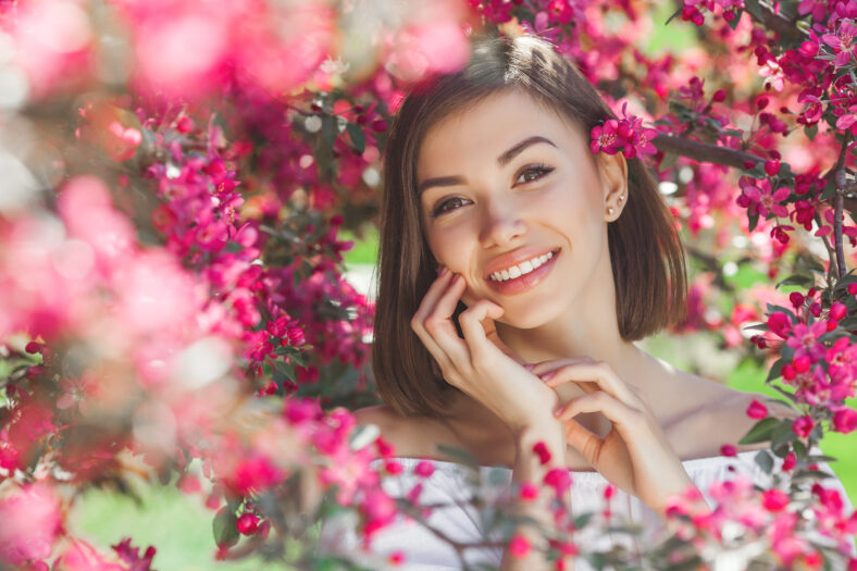 Beautiful lady on floral background. Woman with flowers.