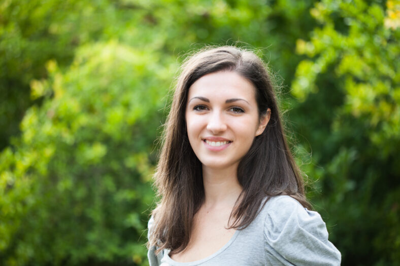 Portrait of a young woman outdoors in a park