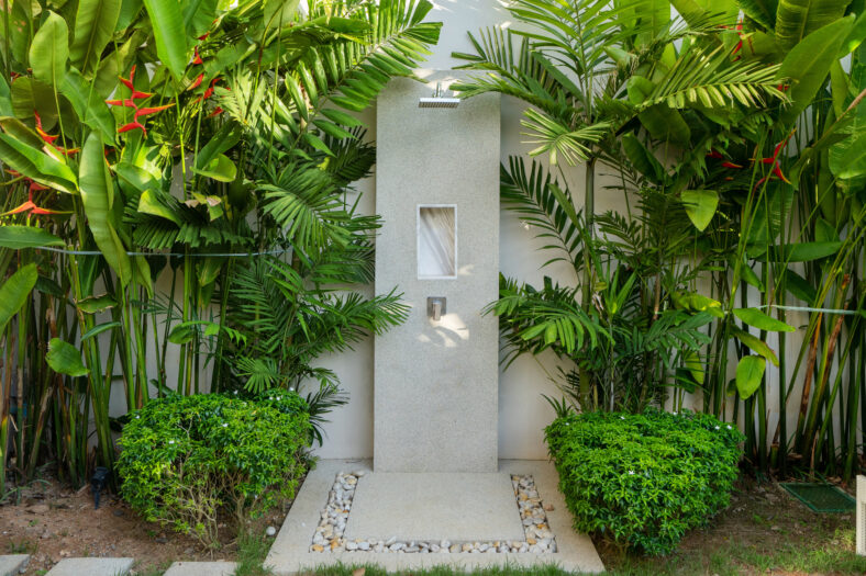 Exterior design of outdoor shower in garden of luxury pool villa, house, home feature rain shower head and garden landscape
