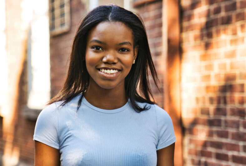 A Outdoor portrait of a Young black African American close to a brick wall