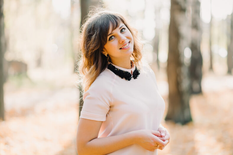 portrait of brunette girl Caucasian appearance smiling in Park in autumn