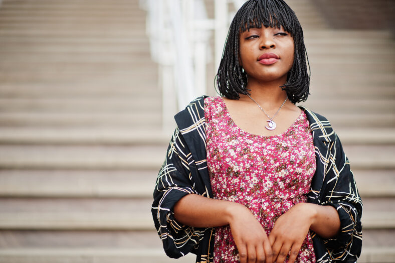 Portrait of beautiful african american woman standing on stairs.