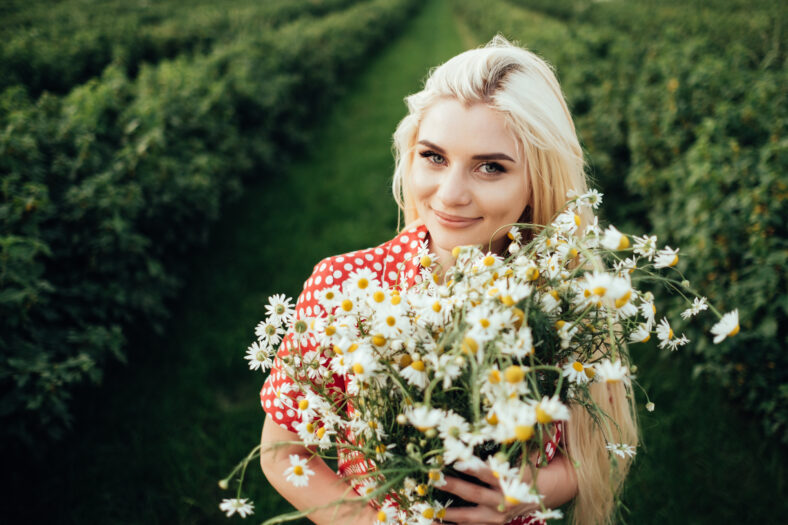Beautiful Young Woman Dressed in Red Polka Dot Dress, Having Fun Time in Field Outside the City, Summertime Concept
