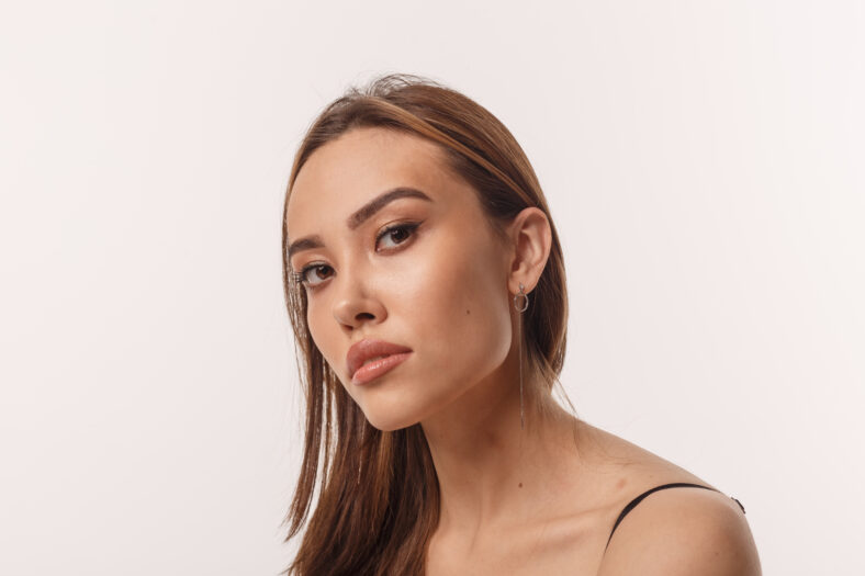 portrait of asian woman with long hair isolated on white background. closeup of skinny girl. attractive female poses in studio