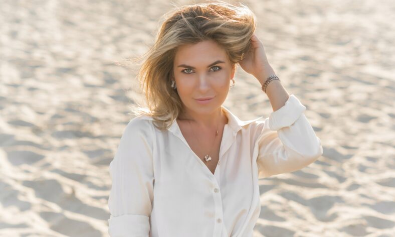 Relax time, elegant woman rest at beach. Nice femininity blonde hair lady, tranquility and freedom concept