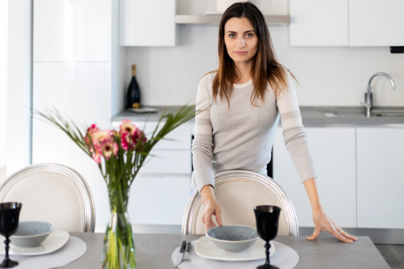 Woman setting the table for dinner