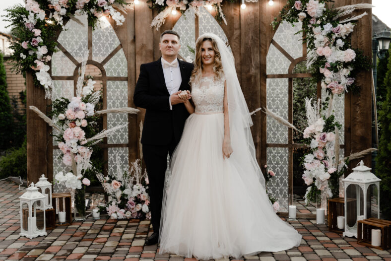 the groom with the bride on the photozone. wedding photo zone. holiday of a young couple.Two hearts of lovers at the wedding ceremony
