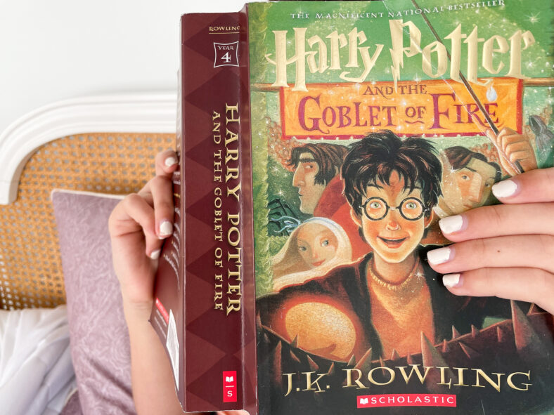 reading Harry Potter novel by J.K. Rowling