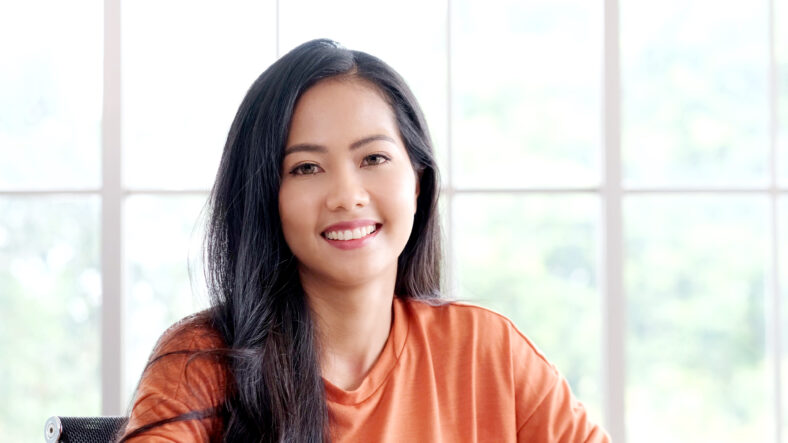 Happy asian girl, Portrait of young asian woman smiling and looking at camera in casual lifestyle while sitting at home office
