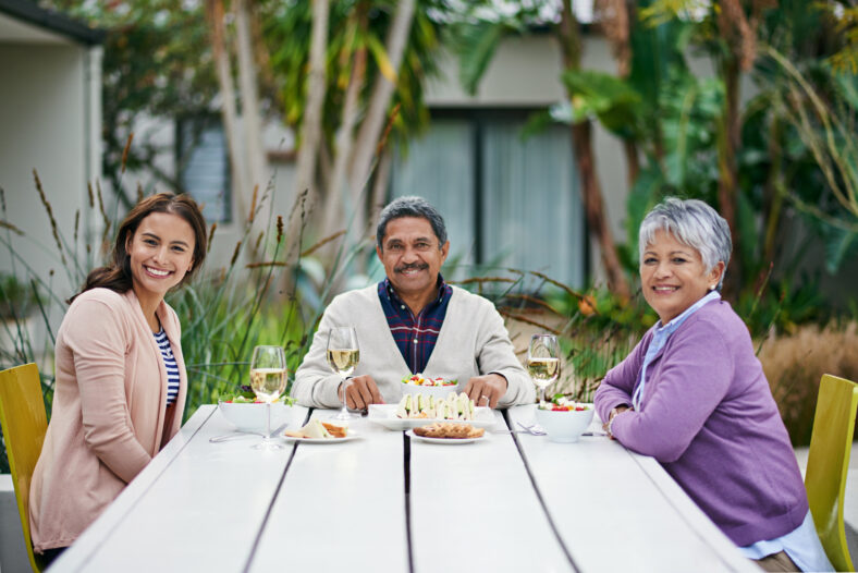 Cropped portrait of a family enjoying lunch together outside.