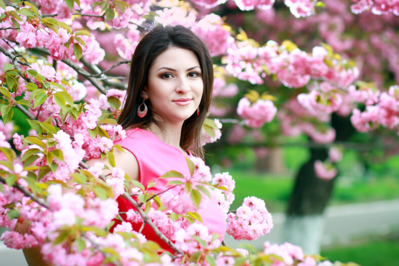 beautiful plus size woman cheerful enjoying over spring Japanese cherry tree background