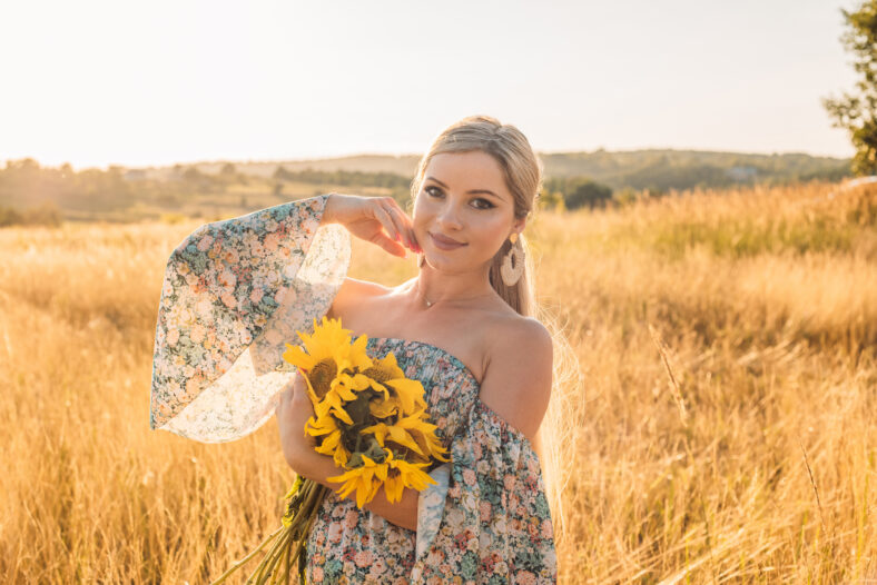 portrait of beautiful happy pregnant woman in countryside during sunset