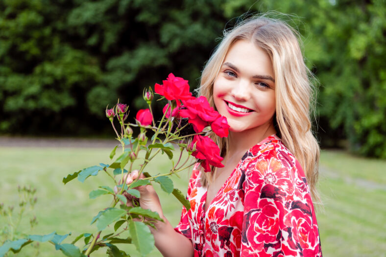 spring girl in fragrant pink flowers in summer blossom park Woman in a blooming garden as Fashion, Cosmetics and Perfumes With Blond Hair Horizontal image Orientation