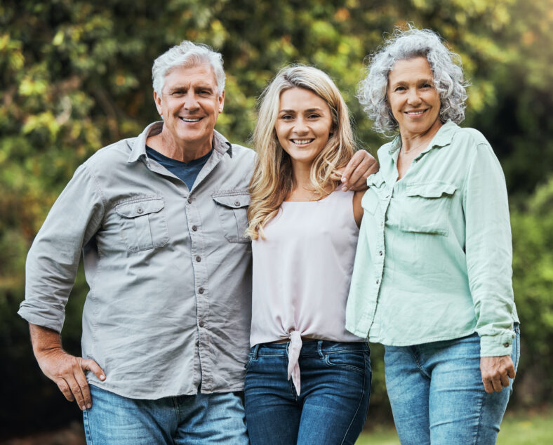 Portrait of mother, father and woman in park on hioliday in Australia together in summer. Happy, relax and love of parents for adult child on vacation in a green garden with family in nature.