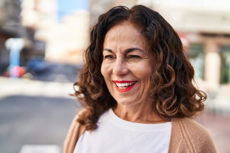 Middle age hispanic woman smiling happy outdoors