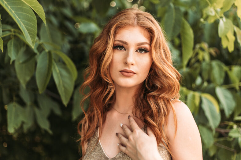 Beautiful ginger teen girl in glamorous golden dress. Ready for her prom night.