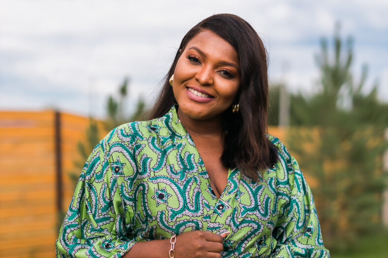 Portrait of beautiful african american woman having fun on village or suburbian. Outdoor portrait of a smiling african girl. Happy cheerful female laughing in countryside summer time concept.