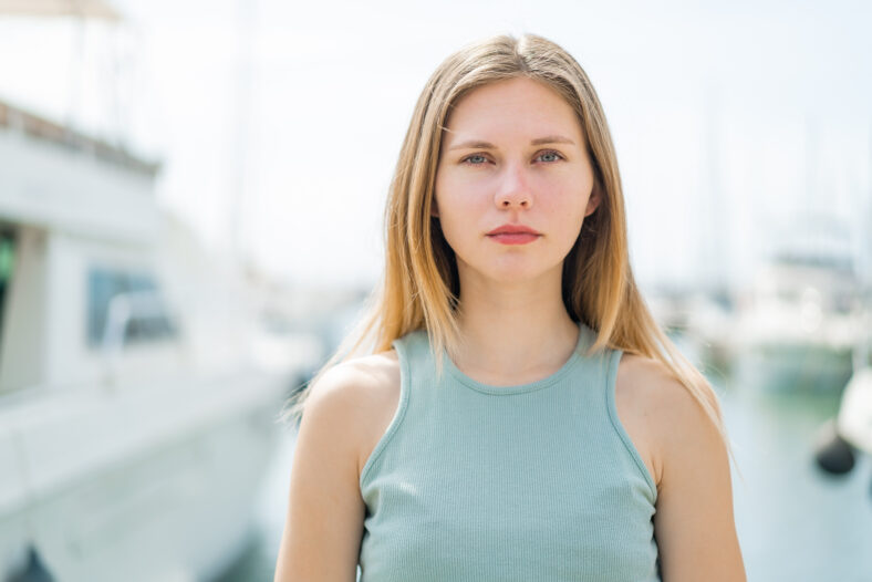 Young blonde woman at outdoors . Portrait