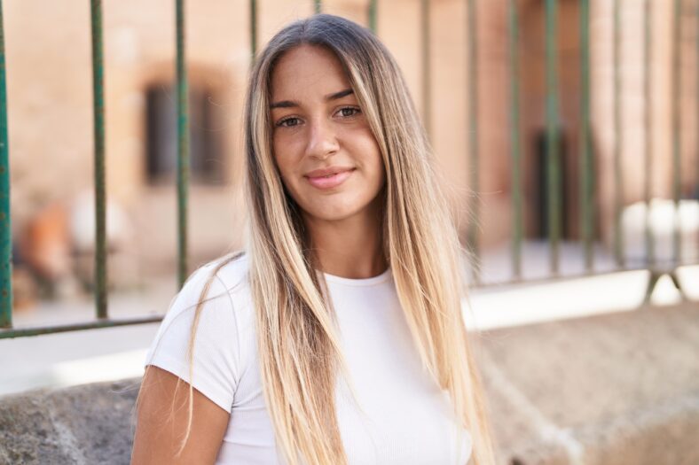 Young beautiful hispanic woman smiling confident standing at street