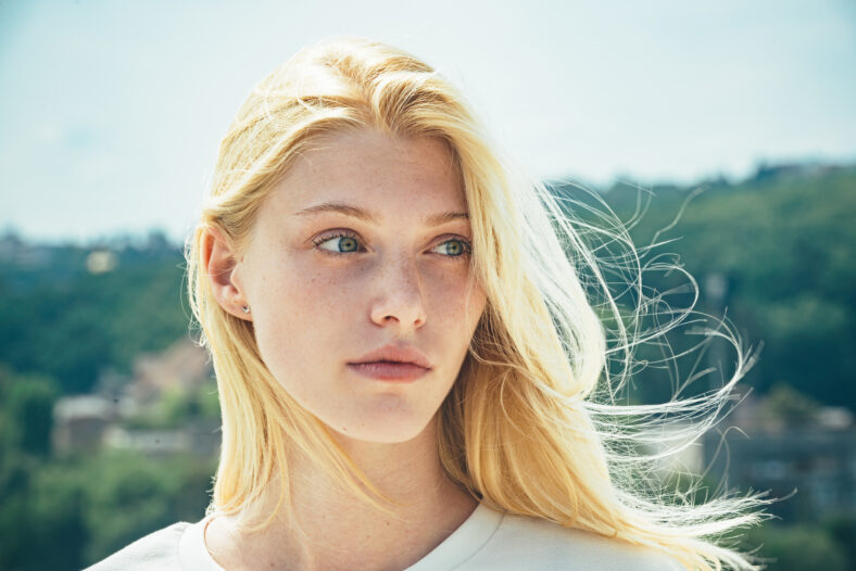 Portrait of young blonde woman outdoor. Romantic girl with beauty face