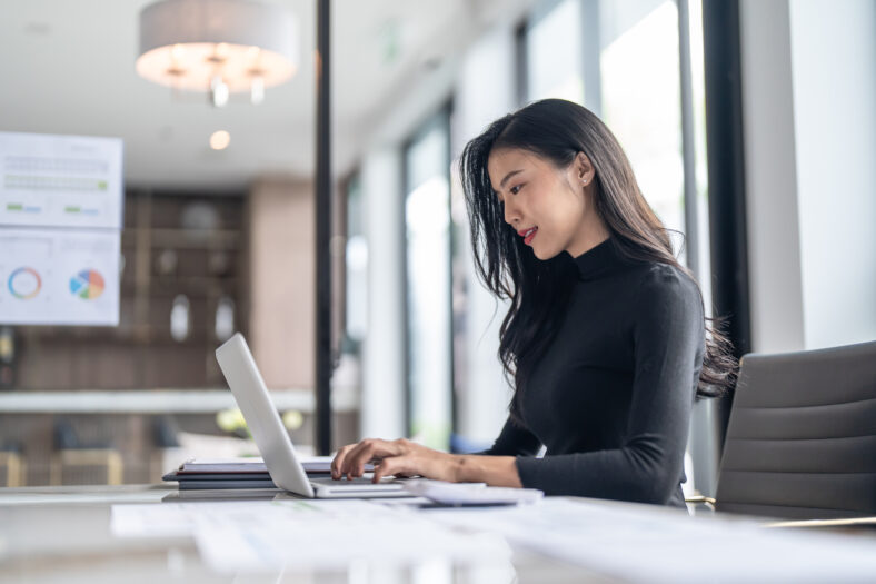 Beautiful confident asian business woman working with laptop Hands typing keyboard. Professional investor working new start up project. business planning in office. Technology business.
