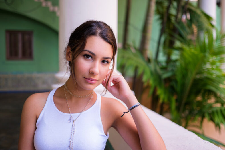 Beautiful young woman in a outdoor courtyard setting.