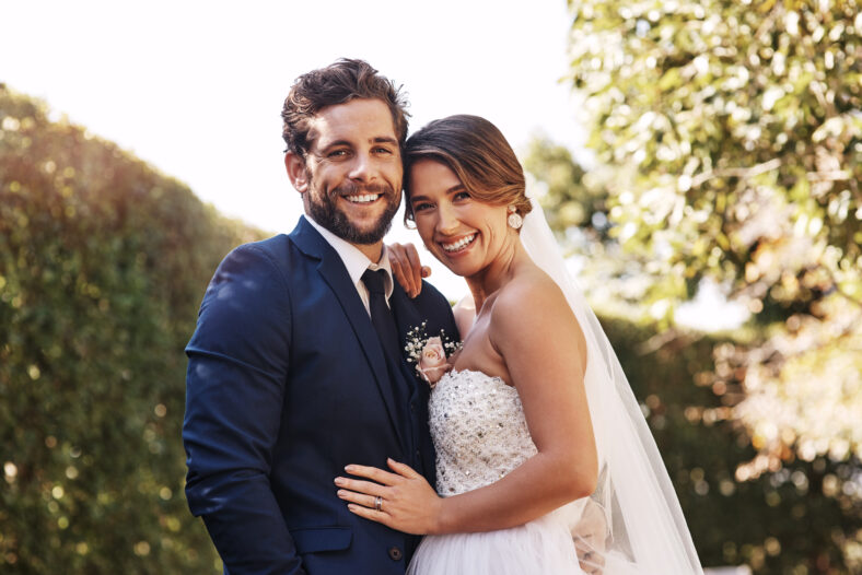 Couple, hug and portrait in outdoor wedding, commitment and promise of loyalty in marriage. People, embrace and celebrate in nature for relationship, support and love for partnership or romance union.