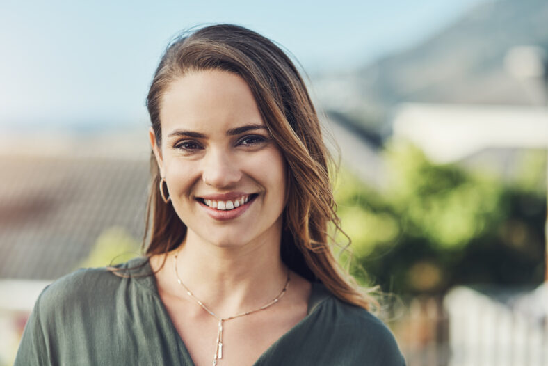 Happy, woman and portrait outdoor with rooftop, smile and work break with urban travel. City, summer and creative professional in Sweden with confidence and sunshine with vacation and holiday trip.