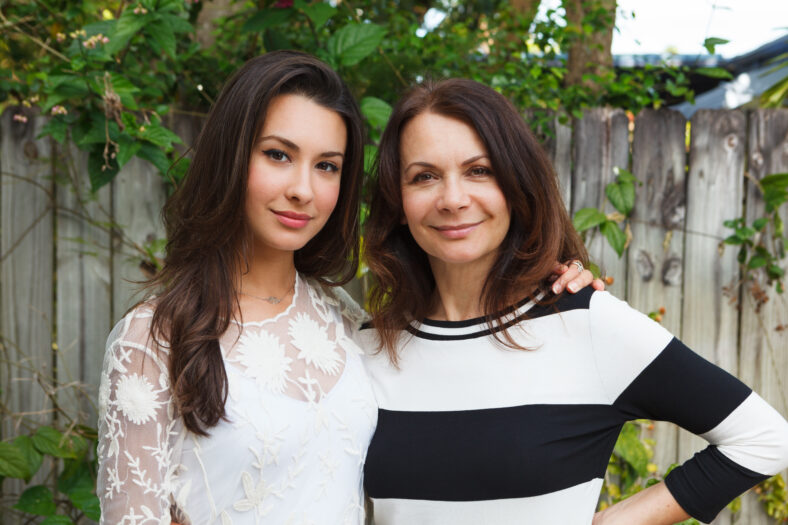 Mother and daughter portrait in a outdoor setting.