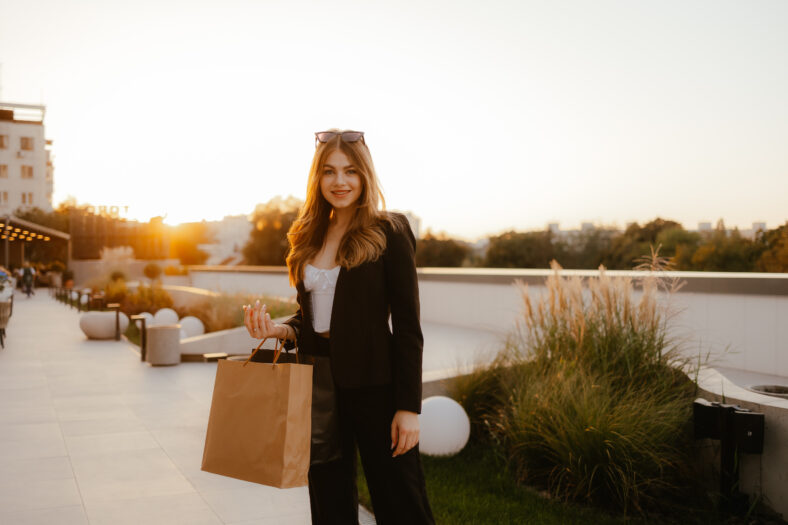 Smiling Woman Shopping Outdoors at Sunset