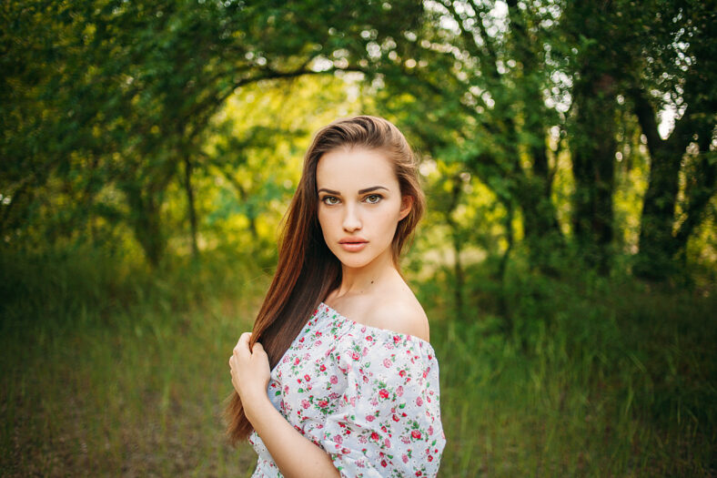 Beautiful young sensual girl with full lips. Portrait of a model on the street