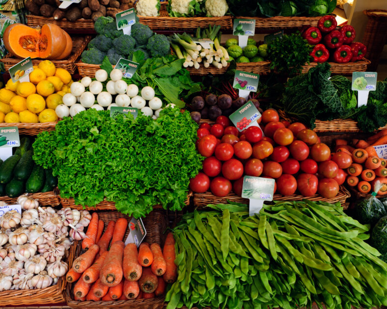 Fresh ripe vegetables on shelves in Mercado dos Lavradores, Funchal, Madeira island, Portugal.