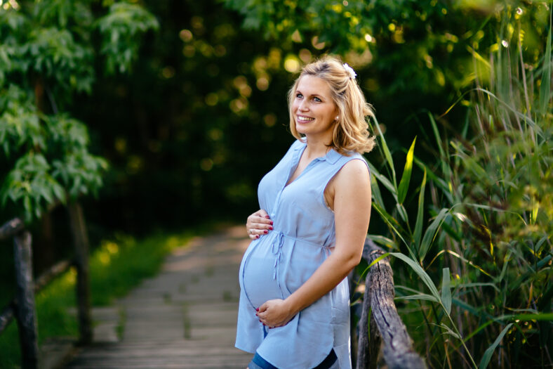 Portrait of a beautiful pregnant woman in nature