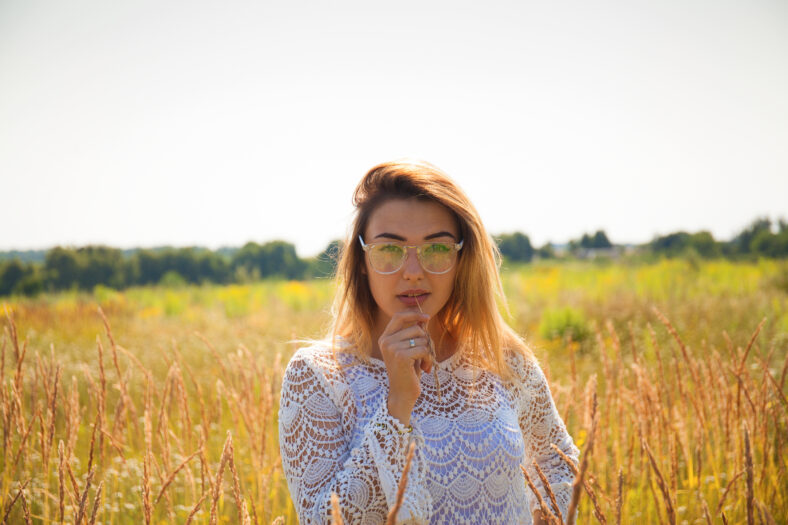 Beautiful young woman in field. Fashion. Teenage model