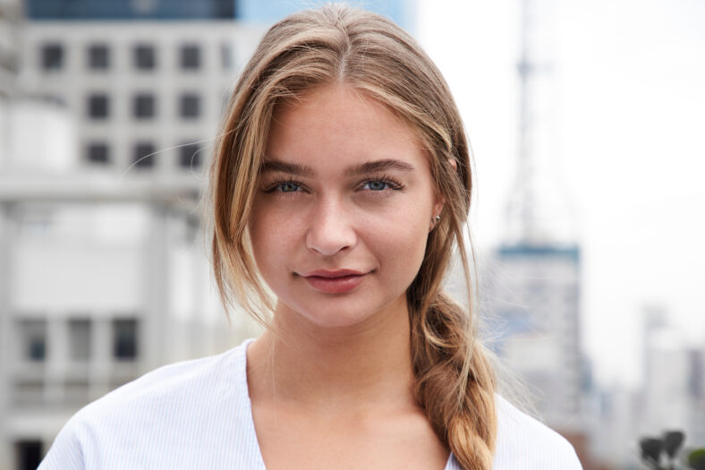 Pretty young woman in city, portrait