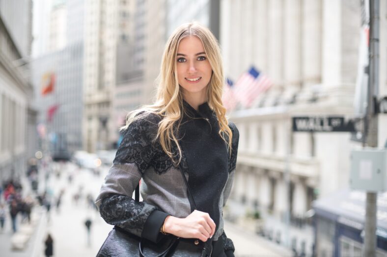 Beautiful elegant lawyer business woman smiling and walking to the court with a bag on a city street