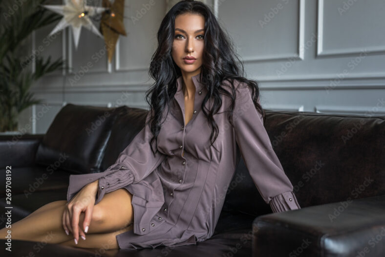 pretty brunette woman sitting on a couch