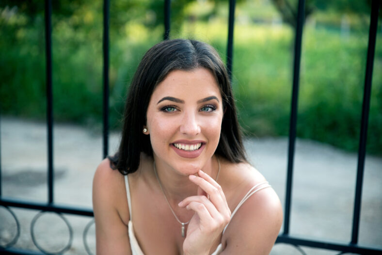 Young smiling woman sitting outdoors