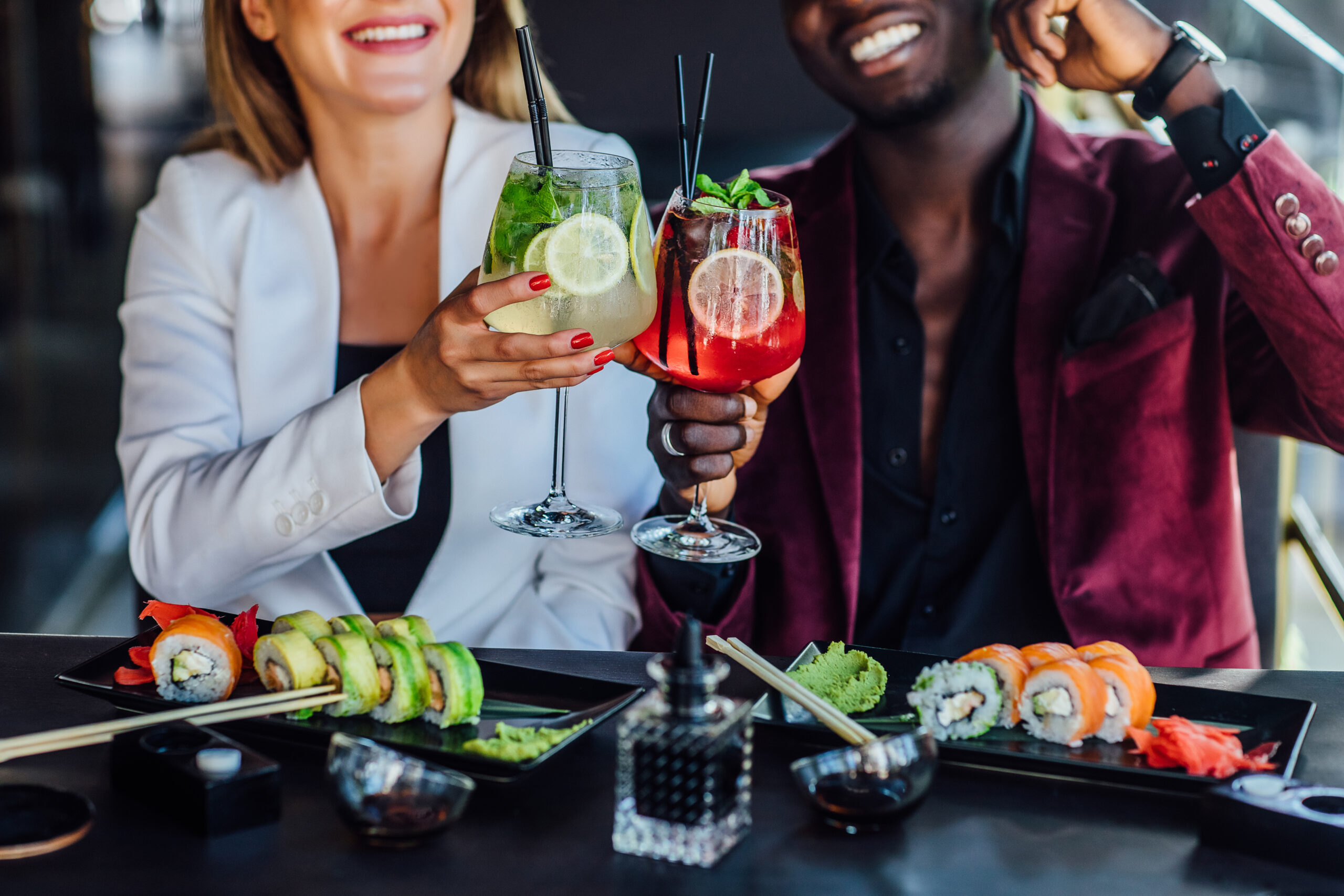 Close up photo. Drinking mojito with sushi in summer terrace.