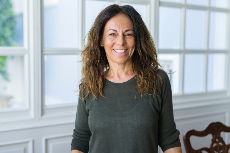 Beautiful middle age woman at home smiling cheerful