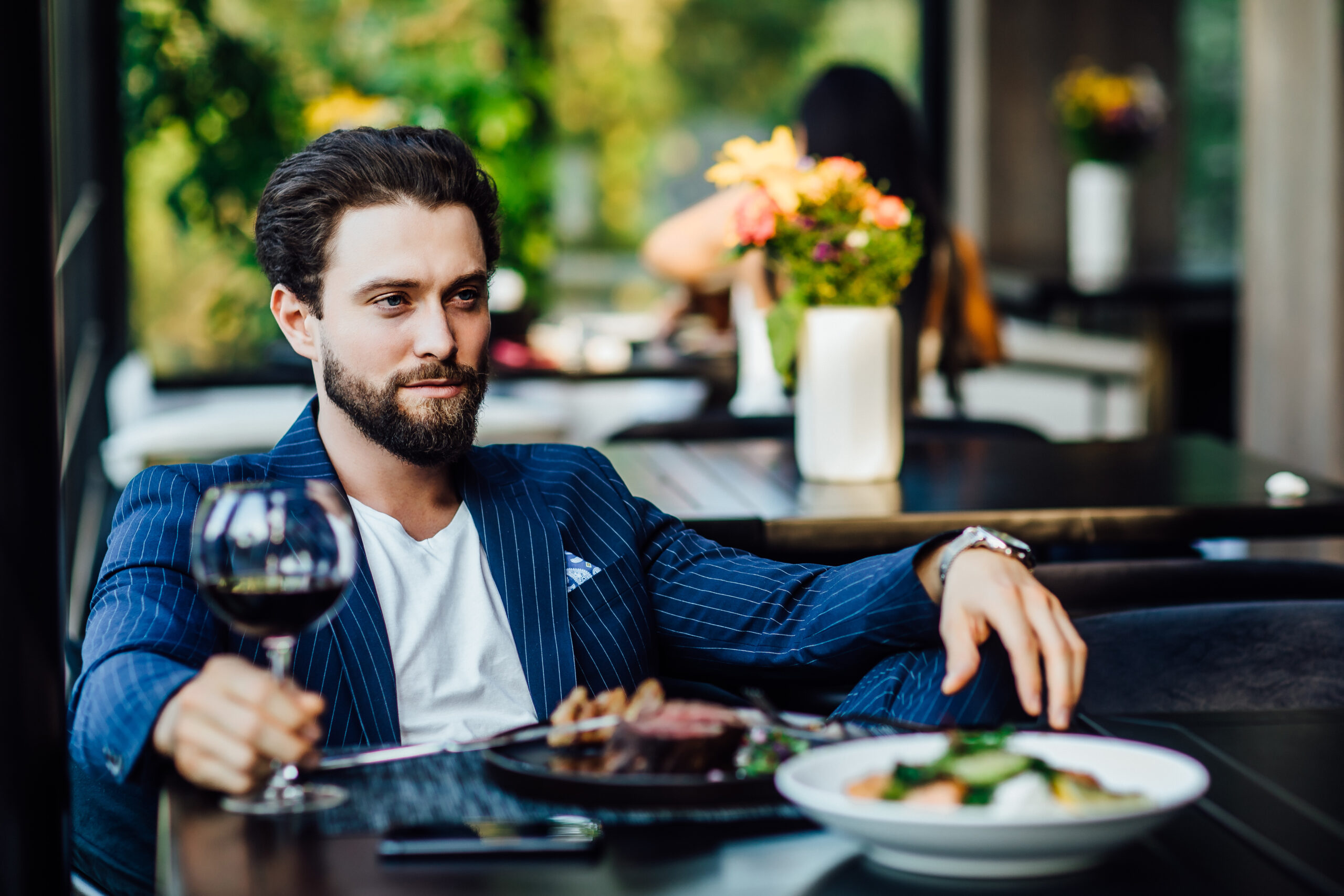 Successful intelligent business man relaxing in a luxury restaurant outdoors, confident thoughtful entrepreneur, wealthy men pensive rest and waiting someone in the modern coffee shop terrace.