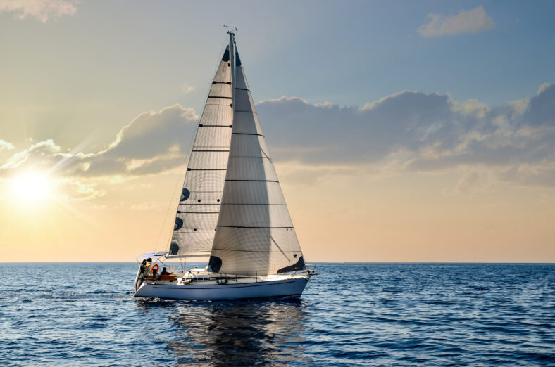 close-up sailboat sailing under a beautiful sunset
