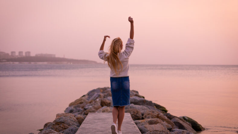 Blonde model on the beach at summer