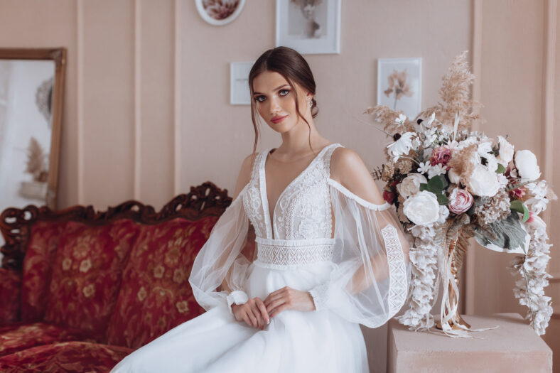 Portrait of beautiful young bride in the airy wedding dress. Delicate female portrait. Wedding make-up. Natural beauty.