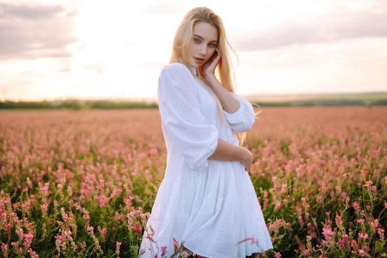 Beautiful woman in the blooming field. Nature, vacation, relax and lifestyle. Summer landscape.