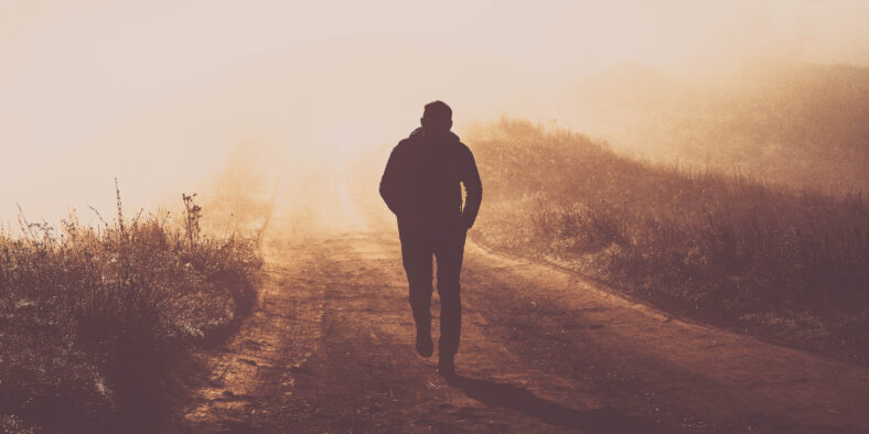 man walking in a foggy autumn landscape