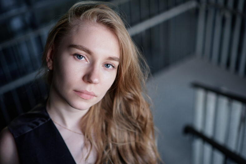Portrait of a attractive young positive adult female on the business background. Student, business woman, services. High quality photo