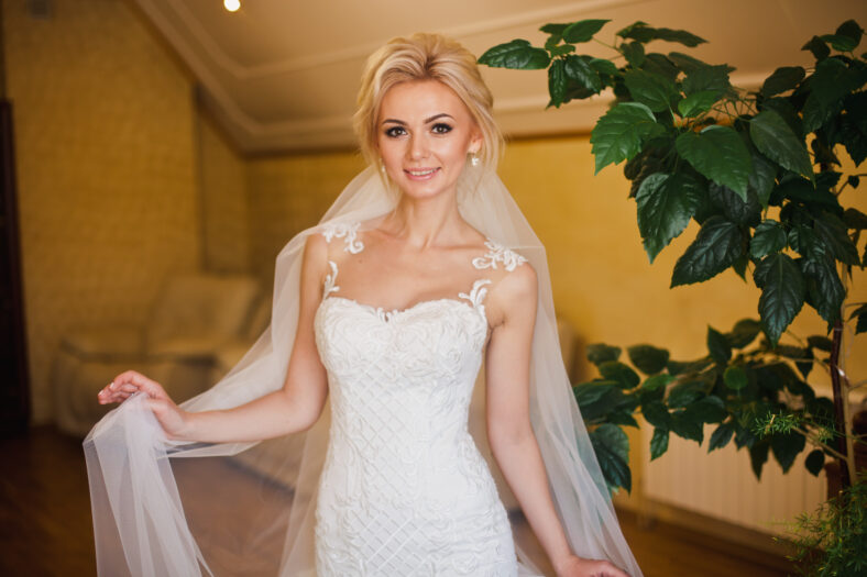 Lovely bride in amazing white dress at home