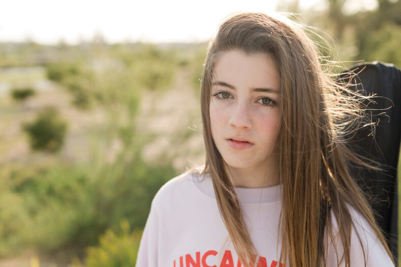 Portrait of a 15 year old teenage girl photographed in backlight