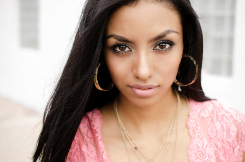 Beautiful exotic young woman with gorgeous face and dark long hair